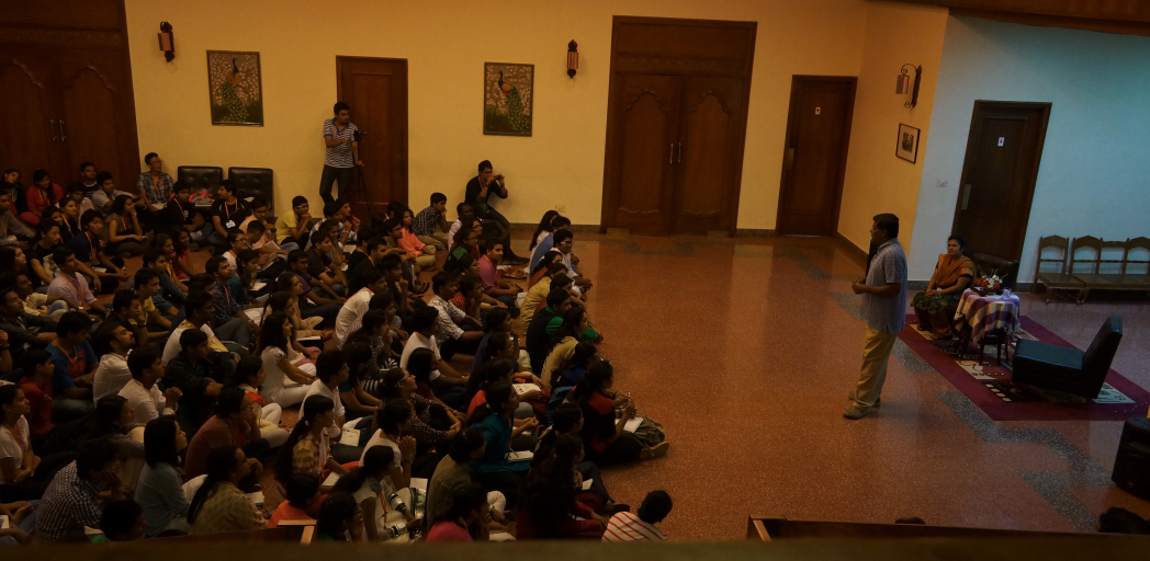 Foyer with audience seated on the floor