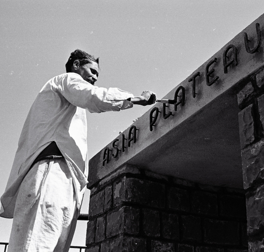 Painting the asia plateau name on the stone wall